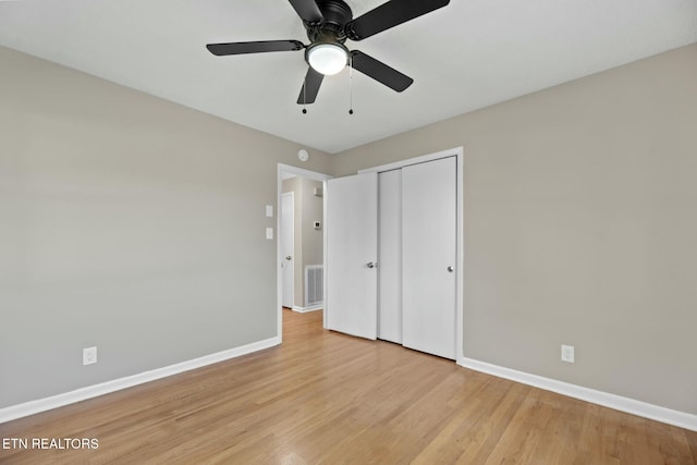 unfurnished bedroom with ceiling fan, light hardwood / wood-style floors, and a closet