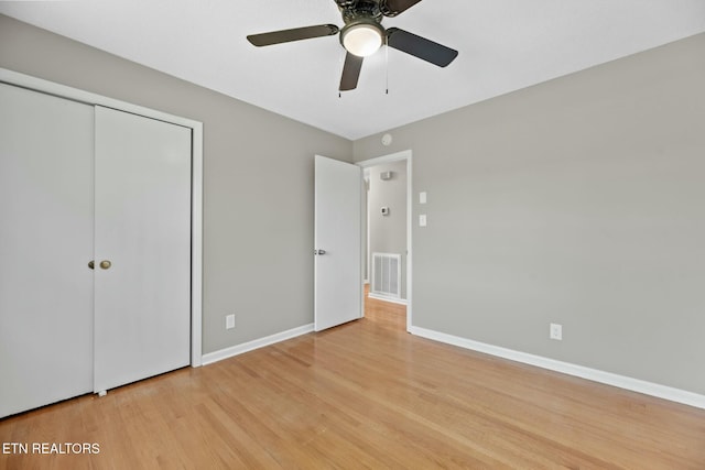 unfurnished bedroom with a closet, ceiling fan, and light hardwood / wood-style flooring