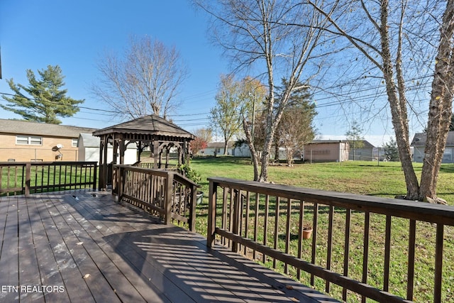 wooden deck featuring a gazebo and a yard