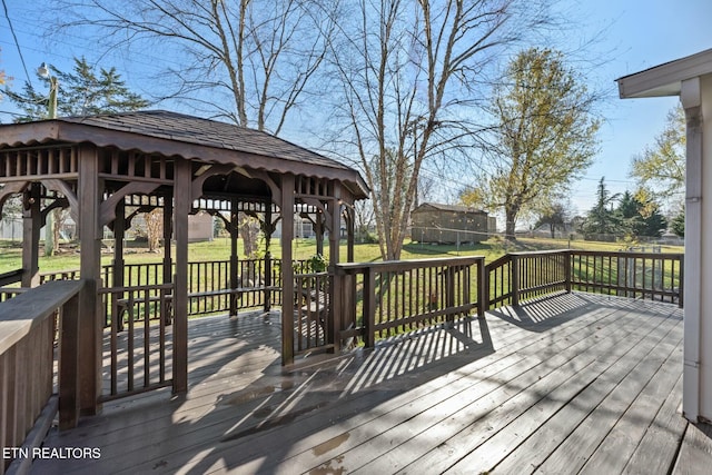 deck featuring a gazebo and a yard