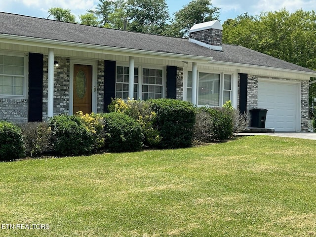 ranch-style house featuring a front yard and a garage