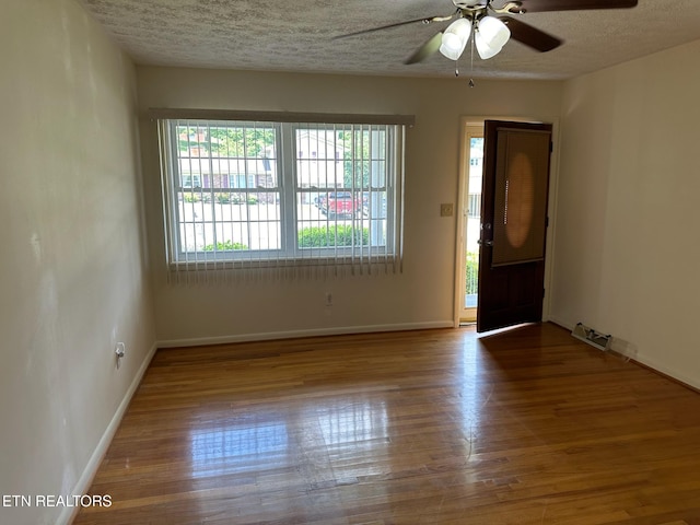 unfurnished room featuring wood-type flooring, a textured ceiling, and ceiling fan