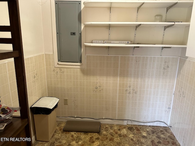 bathroom with electric panel and tile walls