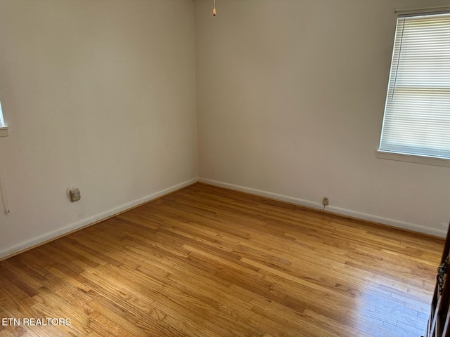 spare room with light hardwood / wood-style flooring