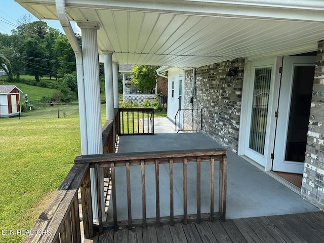 wooden terrace with a yard and a porch