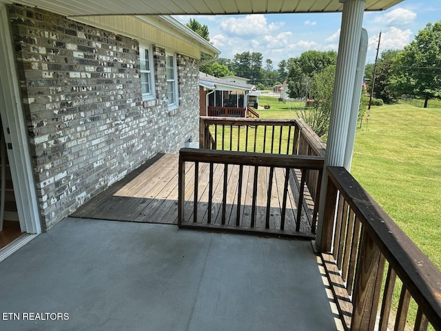 wooden terrace with a yard