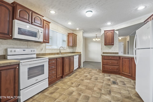 kitchen with ornamental molding, white appliances, sink, decorative light fixtures, and a notable chandelier