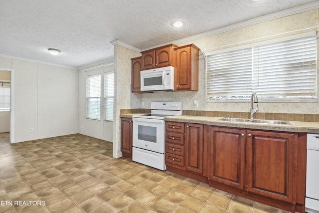 kitchen featuring a textured ceiling, white appliances, sink, and ornamental molding