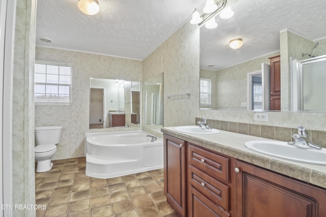 full bathroom with plus walk in shower, vanity, a textured ceiling, and toilet