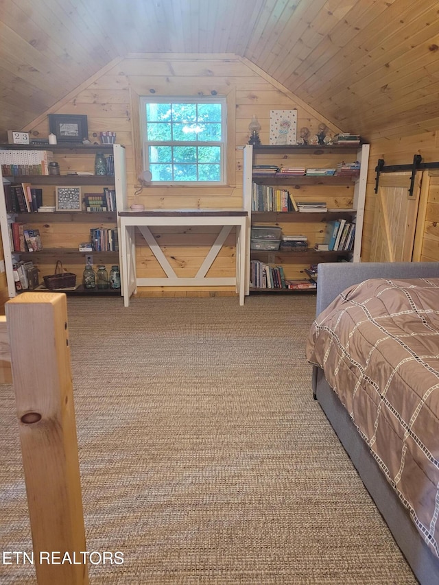 carpeted bedroom featuring a barn door, lofted ceiling, wooden walls, and wooden ceiling