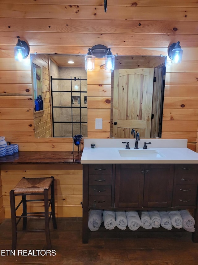 bathroom featuring vanity, wood-type flooring, and wood walls