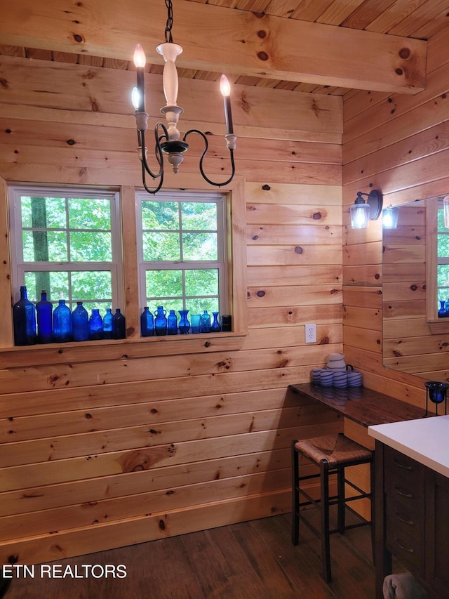 interior space featuring wood walls, an inviting chandelier, wood ceiling, beam ceiling, and hardwood / wood-style floors