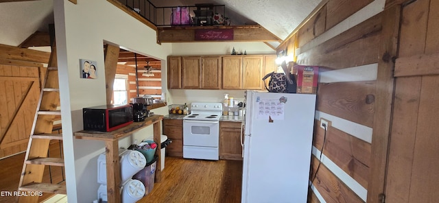 kitchen with a textured ceiling, white appliances, dark hardwood / wood-style floors, and lofted ceiling