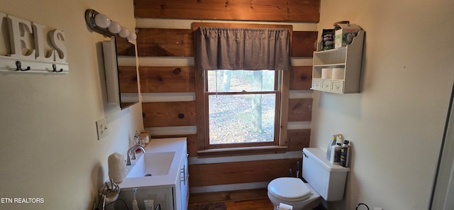 bathroom featuring vanity, hardwood / wood-style flooring, and toilet