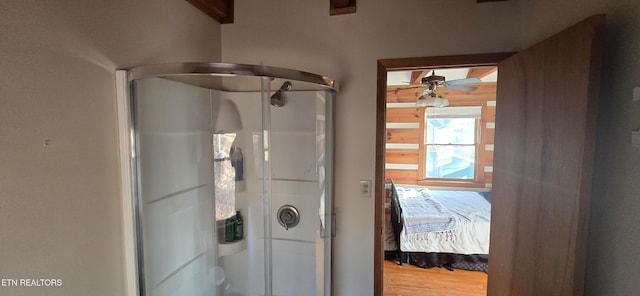 bathroom with ceiling fan, hardwood / wood-style floors, and an enclosed shower