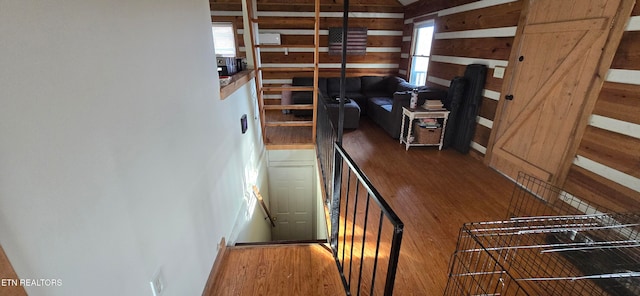 stairway with hardwood / wood-style floors