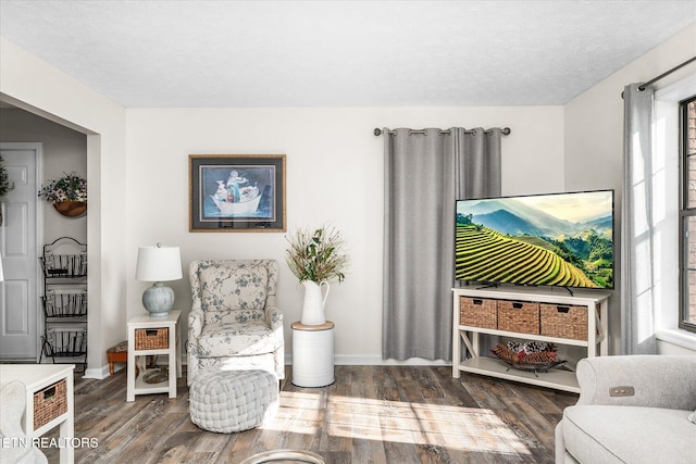 sitting room featuring a textured ceiling and dark hardwood / wood-style floors