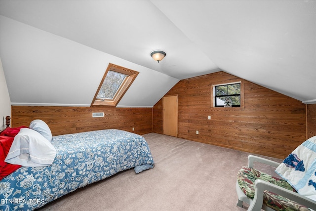 carpeted bedroom featuring wood walls and vaulted ceiling