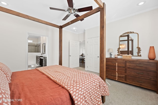 carpeted bedroom featuring ensuite bath, ceiling fan, and crown molding