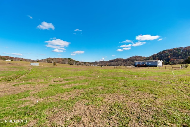 view of yard featuring a mountain view and a rural view