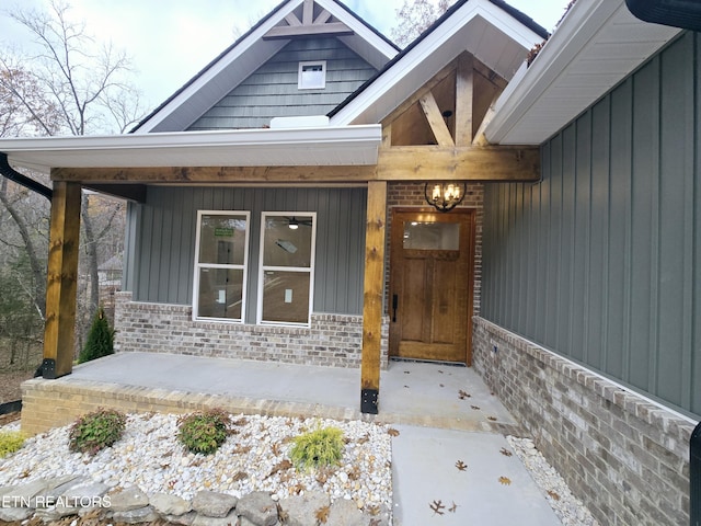 324 Nuhya Ln, Loudon, TN 37774 - doorway to property featuring a porch, brick siding, and board and batten siding
