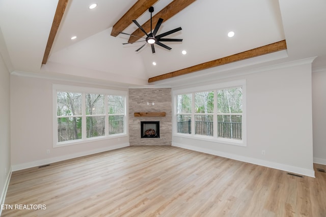 unfurnished living room featuring wood finished floors, baseboards, a ceiling fan, beam ceiling, and a fireplace