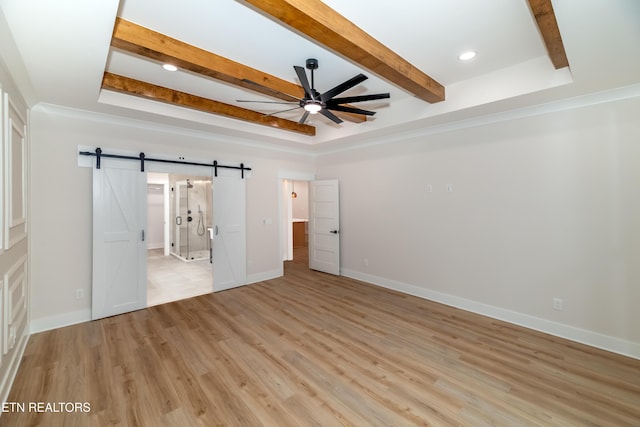 unfurnished bedroom featuring baseboards, beam ceiling, recessed lighting, light wood-style floors, and a barn door