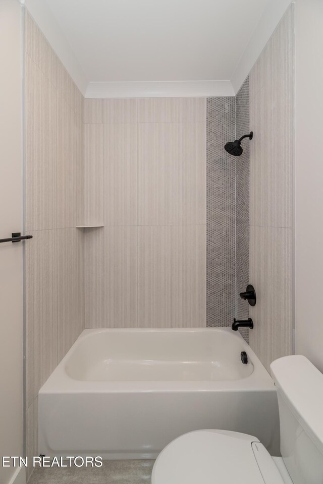 bathroom featuring shower / bathing tub combination, toilet, and ornamental molding