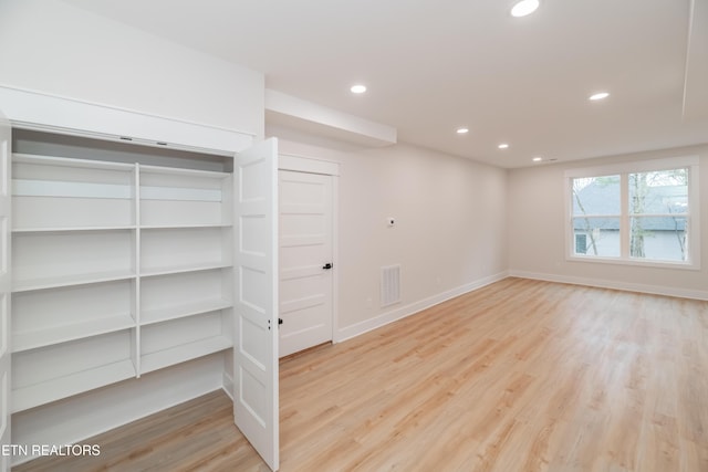 interior space featuring recessed lighting, visible vents, baseboards, and wood finished floors