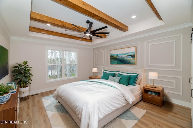 bedroom featuring beam ceiling, a tray ceiling, recessed lighting, light wood finished floors, and baseboards