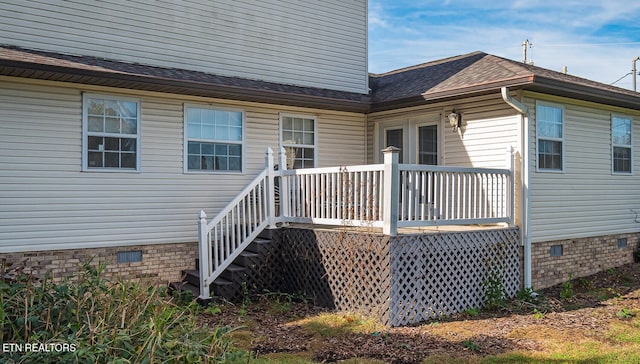 view of exterior entry with a wooden deck