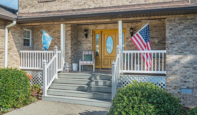 property entrance with covered porch