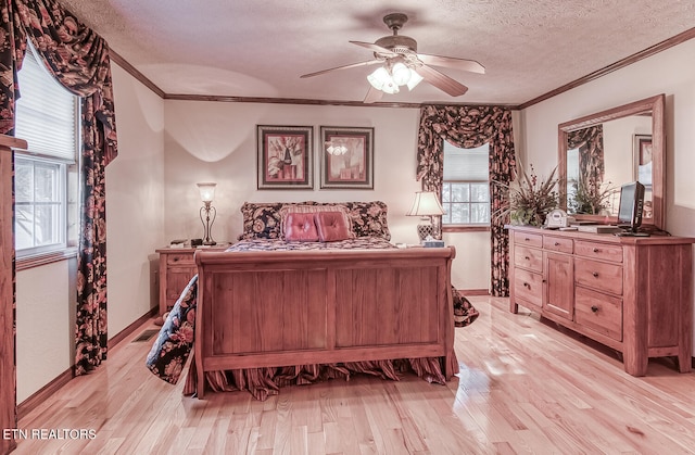 bedroom with a textured ceiling, light wood-type flooring, ceiling fan, and ornamental molding