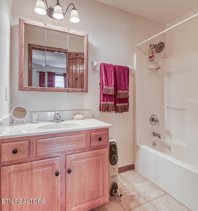 bathroom featuring tile patterned flooring, vanity, shower / washtub combination, and a textured ceiling