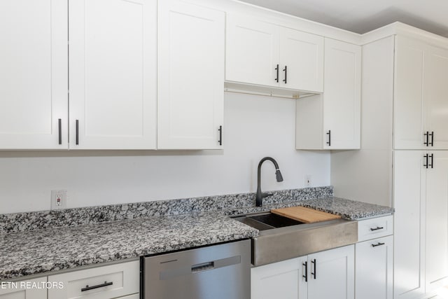 kitchen featuring light stone counters, sink, white cabinets, and dishwasher