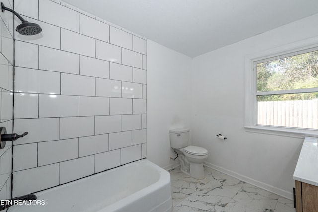 full bathroom with vanity, toilet, and tiled shower / bath combo