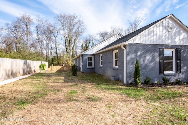 view of property exterior with a lawn