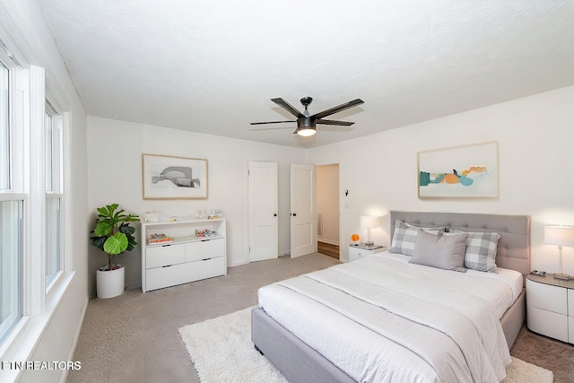 carpeted bedroom with ceiling fan