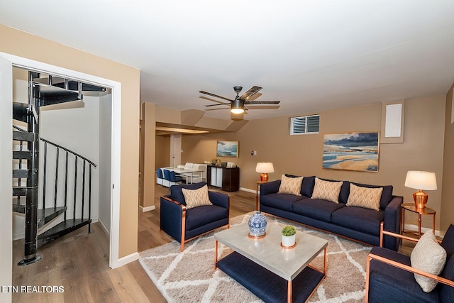 living room featuring ceiling fan and light hardwood / wood-style floors