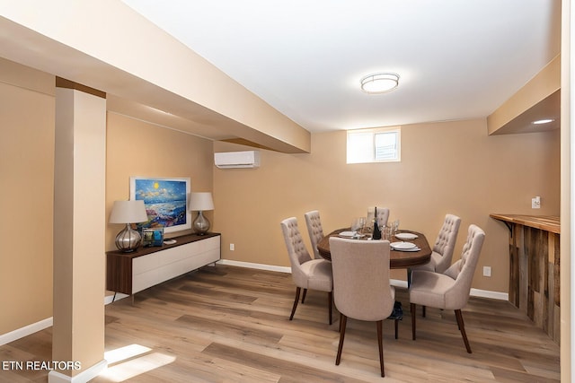 dining area with hardwood / wood-style flooring and a wall mounted AC