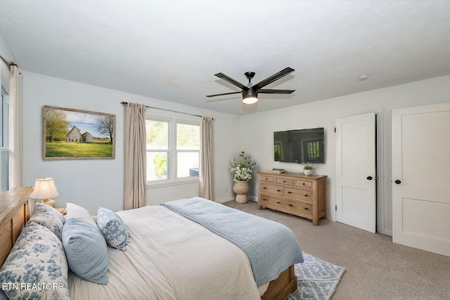 carpeted bedroom with ceiling fan