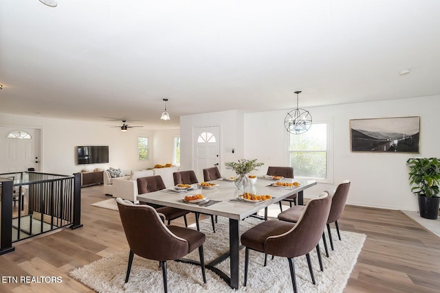 dining area with a chandelier and light hardwood / wood-style floors