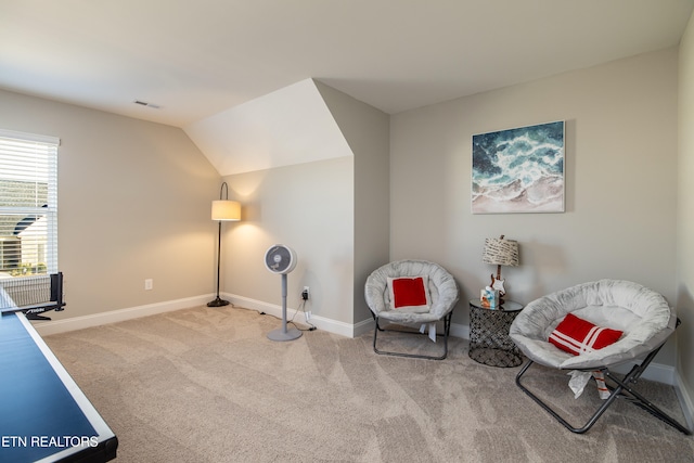 living area with light colored carpet and lofted ceiling