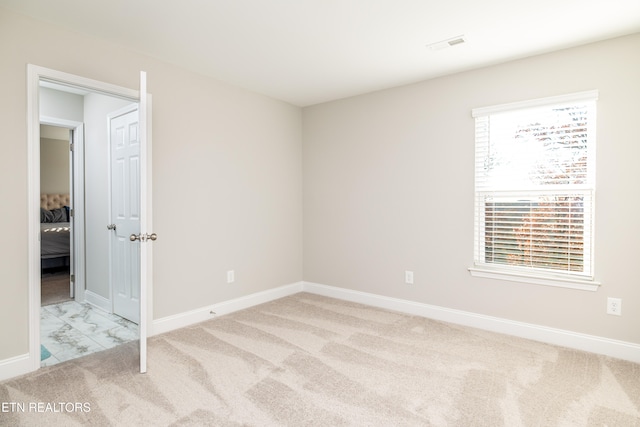 unfurnished room with light colored carpet