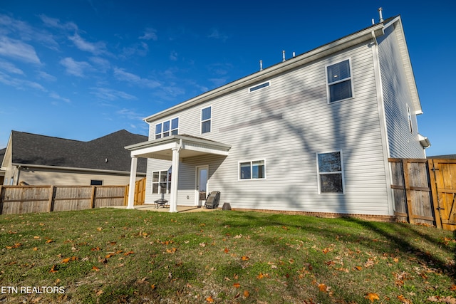 back of house featuring a yard and a patio