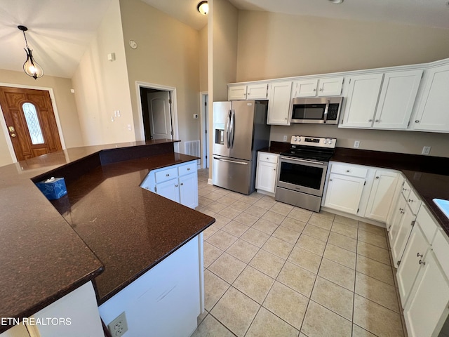 kitchen featuring appliances with stainless steel finishes, pendant lighting, high vaulted ceiling, white cabinets, and light tile patterned flooring