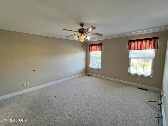 carpeted empty room featuring ceiling fan and ornamental molding