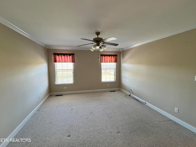 spare room with light carpet, ceiling fan, and crown molding