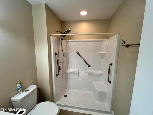 bathroom with toilet and walk in shower