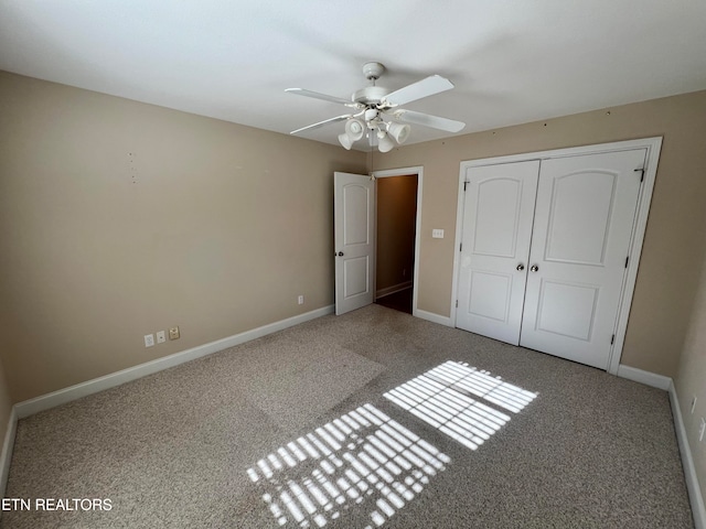 unfurnished bedroom featuring carpet, ceiling fan, and a closet